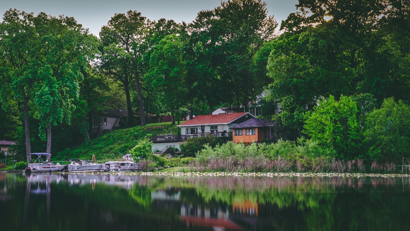 Single-story lake home with a private dock on a wooded Minnesota lake